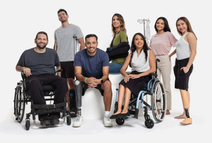 Seven people standing and sitting, two in wheelchairs